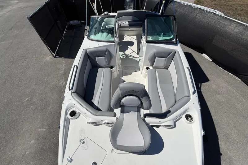 Slide: The Image of 2021 NauticStar 203 DC boat with gray seating and open deck layout. - 41