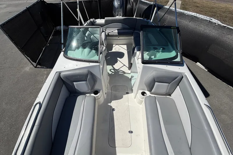 Slide: The Image of 2021 NauticStar 203 DC boat interior with gray seating and dual consoles. - 43