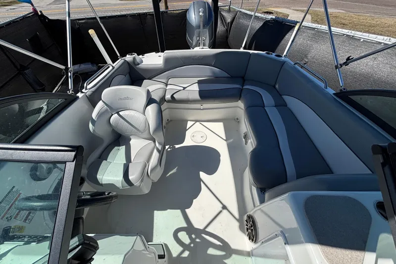 Slide: The Image of 2021 NauticStar 203 DC boat interior with gray seating and steering wheel. - 49