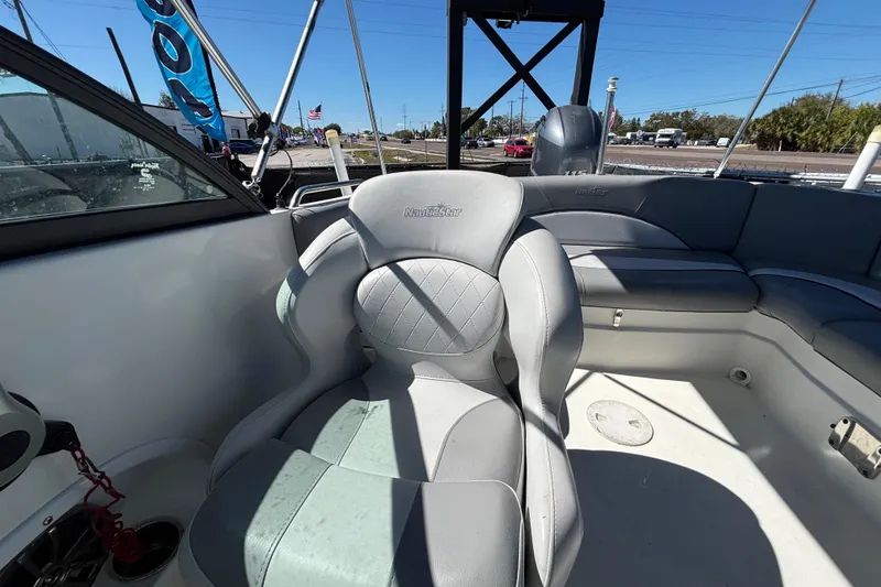 Slide: The Image of 2021 NauticStar 203 DC boat interior with gray seating and steering area. - 52