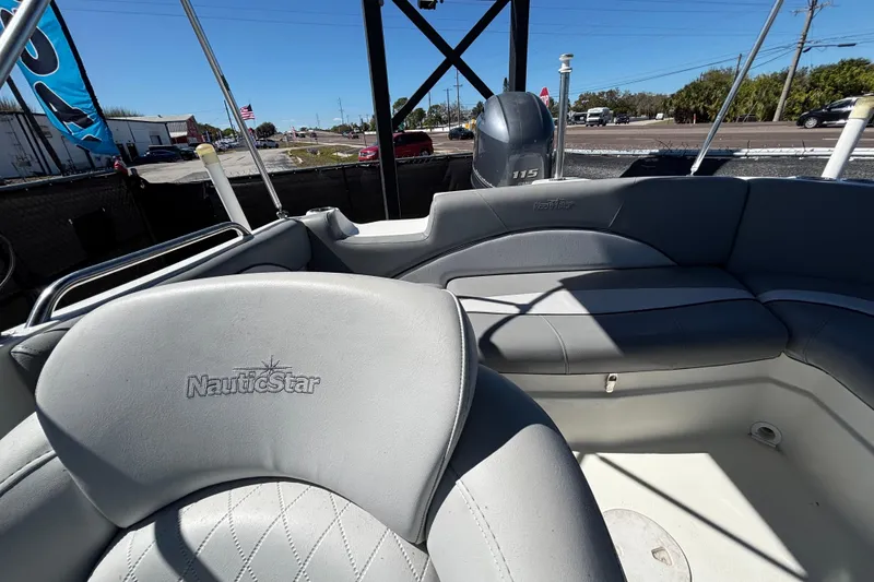 Slide: The Image of 2021 NauticStar 203 DC boat interior with gray seating and Yamaha 115 engine. - 53