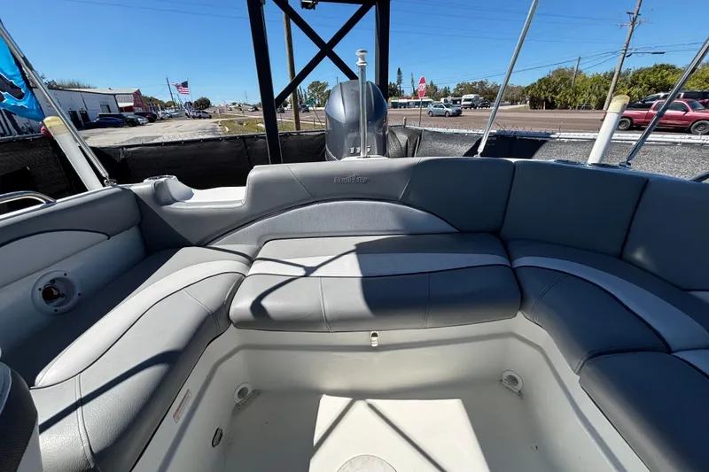 Slide: The Image of 2021 NauticStar 203 DC boat interior with gray seating and open deck. - 54