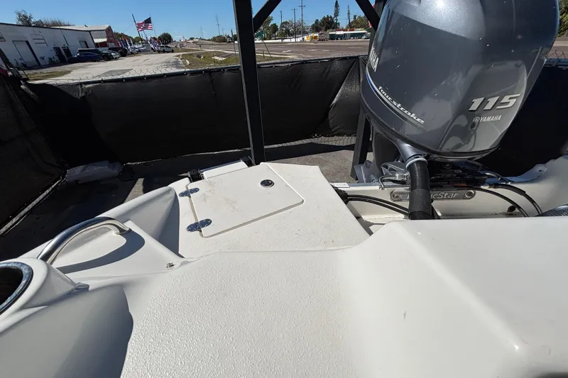 Slide: The Image of 2021 NauticStar 203 DC boat with Yamaha 115 engine, docked outdoors. - 62