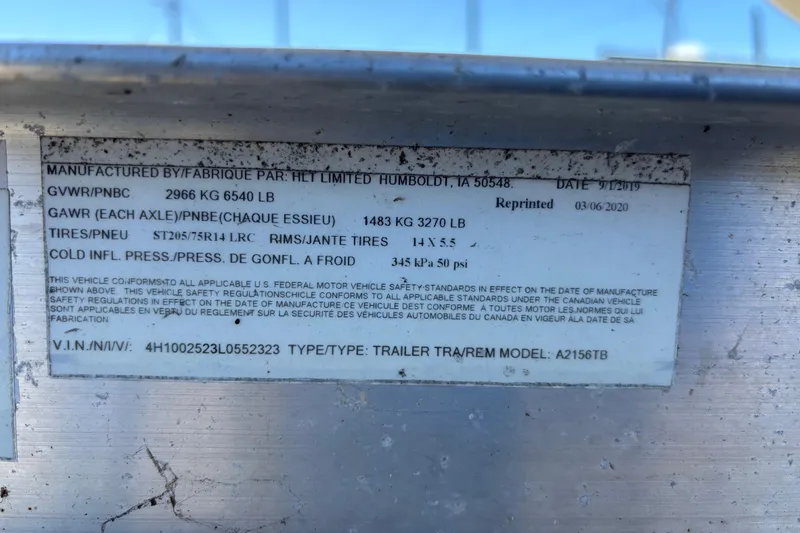 Slide: The Image of Label on a NauticStar 203 DC 2021 boat trailer, detailing specifications and compliance information. - 64