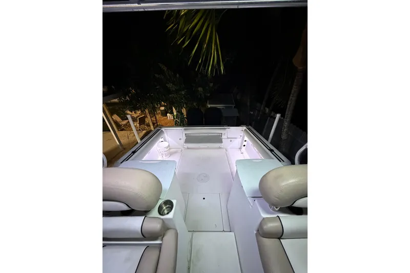 Slide: The Image of 2001 Wellcraft 270 Coastal O/B boat interior at night, featuring seating and deck. - 13