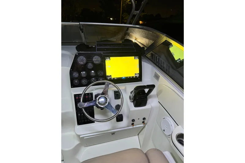 Slide: The Image of 2001 Wellcraft 270 Coastal O/B boat dashboard with steering wheel and navigation system. - 15