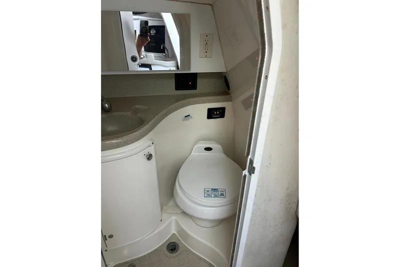 Slide: The Image of 2001 Wellcraft 270 Coastal O/B boat bathroom with sink and toilet. - 8