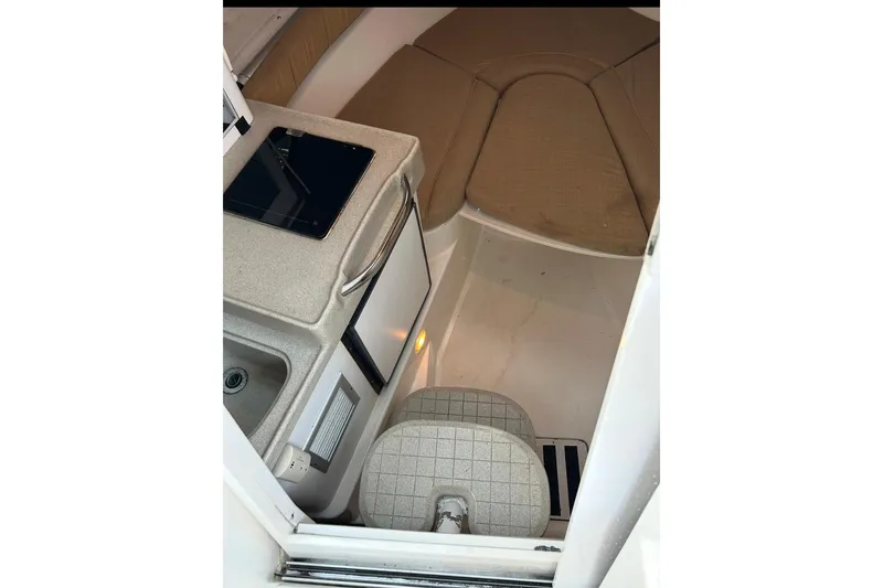 Slide: The Image of 2001 Wellcraft 270 Coastal O/B cabin interior with kitchenette and seating area. - 9
