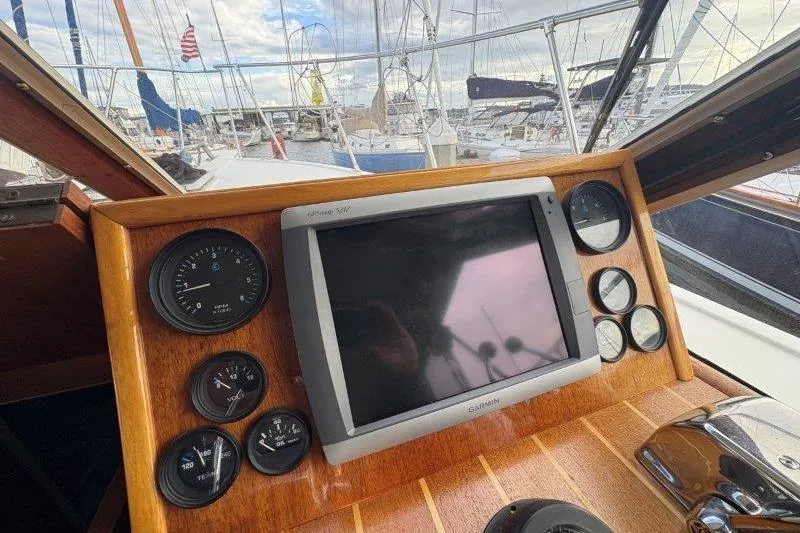 Slide: The Image of 1987 Tollycraft 34 Sundeck Motor Yacht helm with DC control panel and steering wheel. - 28
