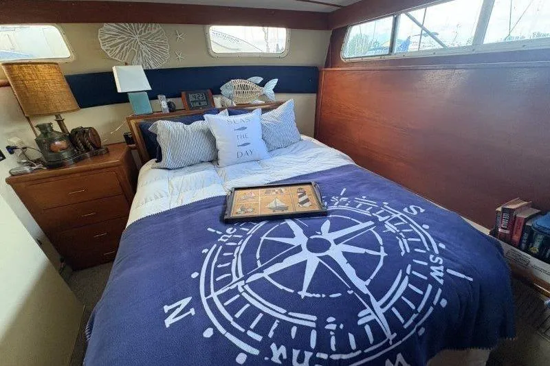 Slide: The Image of Cozy bedroom in 1987 Tollycraft 34 Sundeck Motor Yacht with nautical decor. - 36