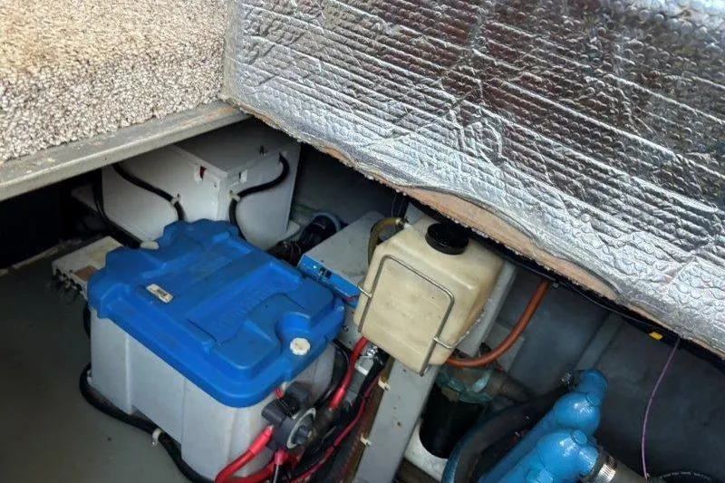 Slide: The Image of Engine compartment of 1987 Tollycraft 34 Sundeck Motor Yacht, featuring blue components and wiring. - 49