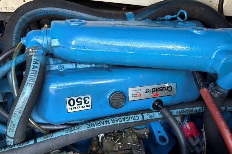 Slide: The Image of Engine room of 1987 Tollycraft 34 Sundeck Motor Yacht with red machinery and cables. - 51