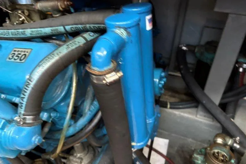 Slide: The Image of Engine of 1987 Tollycraft 34 Sundeck Motor Yacht, Crusader Model 350, blue with marine hoses. - 52