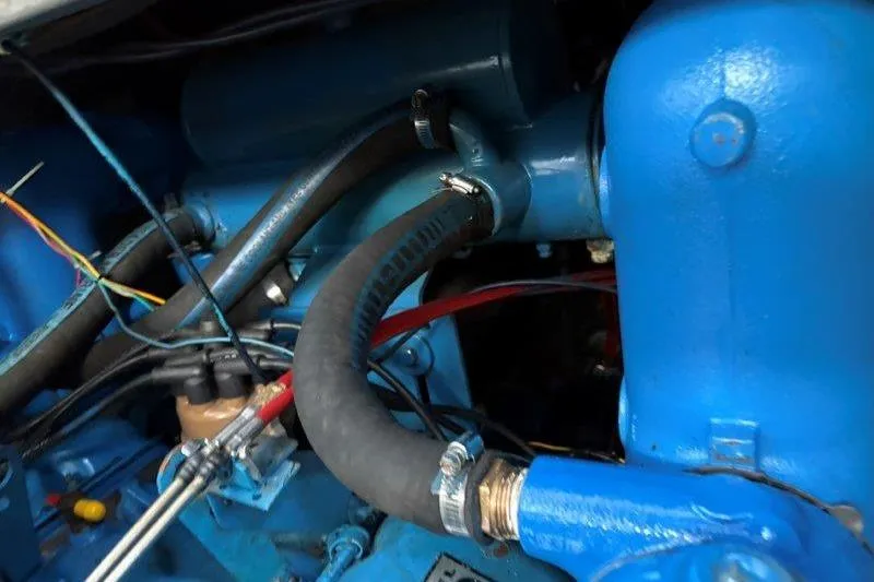 Slide: The Image of Engine of 1987 Tollycraft 34 Sundeck Motor Yacht, featuring blue components and belts. - 56