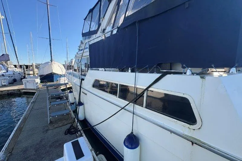 Slide: The Image of Engine compartment of a 1987 Tollycraft 34 Sundeck Motor Yacht, showing hoses and wiring. - 60