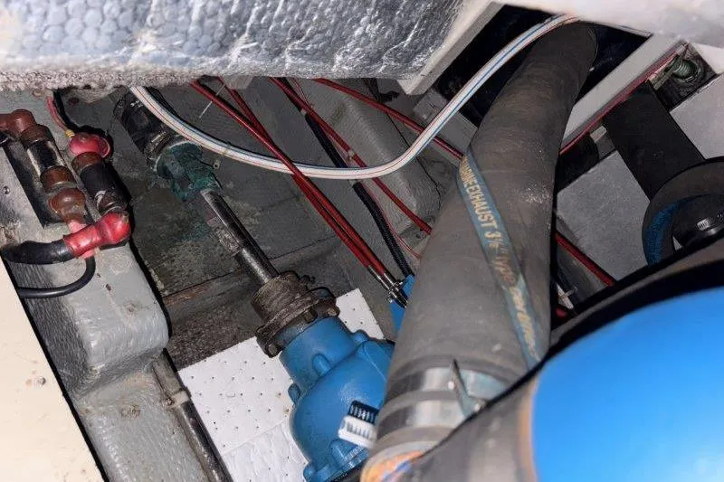 Slide: The Image of Engine compartment of a 1987 Tollycraft 34 Sundeck Motor Yacht, showing hoses and wiring. - 61