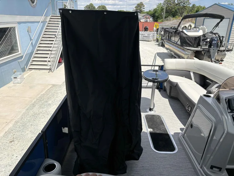 Slide: The Image of Sylvan X-5 CLZ DH 2026 pontoon boat with black curtain and seating area. - 11