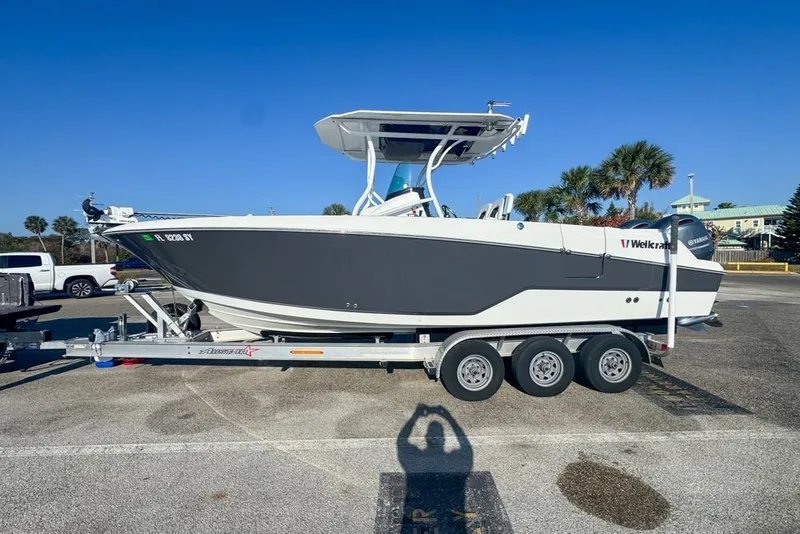 Slide: The Image of 2021 Wellcraft 262 Fisherman boat on trailer in sunny parking lot. - 10