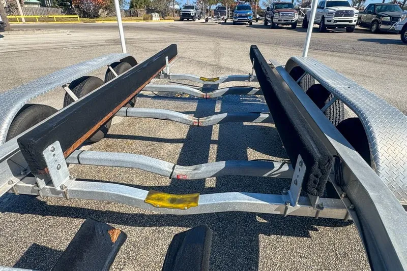 Slide: The Image of Boat trailer for 2021 Wellcraft 262 Fisherman, parked in a lot with vehicles. - 101