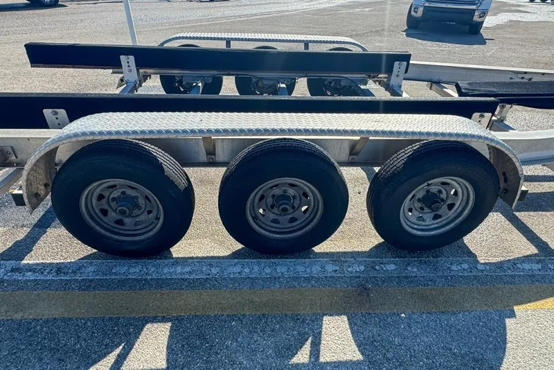Slide: The Image of Triple-axle trailer for 2021 Wellcraft 262 Fisherman boat, parked on asphalt. - 104
