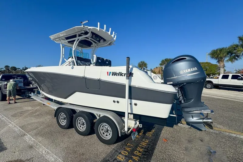 Slide: The Image of 2021 Wellcraft 262 Fisherman boat on trailer with Yamaha engine, parked outdoors. - 11