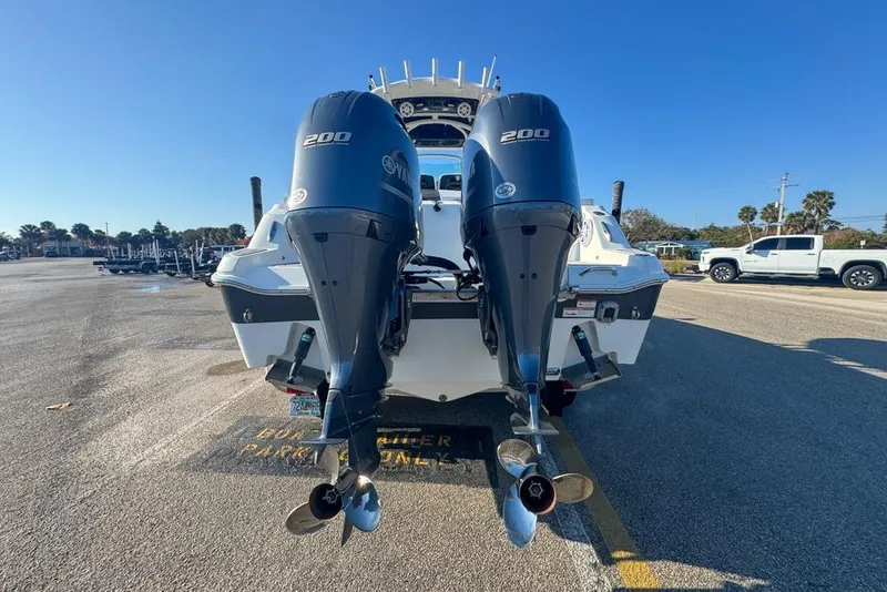 Slide: The Image of 2021 Wellcraft 262 Fisherman boat with dual Yamaha 200 engines in parking lot. - 12