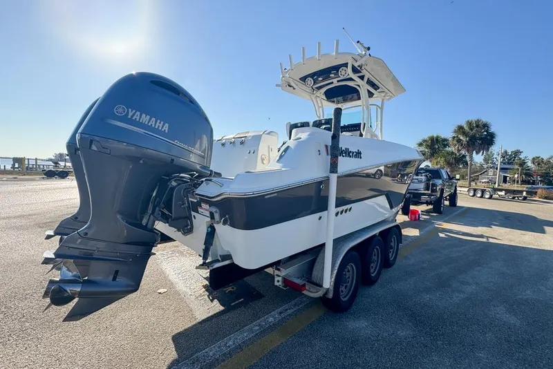 Slide: The Image of 2021 Wellcraft 262 Fisherman boat on trailer with Yamaha engine, parked outdoors. - 13