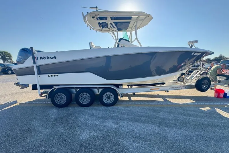 Slide: The Image of 2021 Wellcraft 262 Fisherman boat on trailer in sunny parking lot. - 14