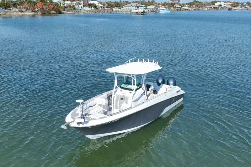 Slide: The Image of 2021 Wellcraft 262 Fisherman boat on calm water, showcasing sleek design and dual engines. - 18