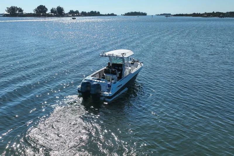 Slide: The Image of 2021 Wellcraft 262 Fisherman boat cruising on a sunny, tranquil waterway. - 23