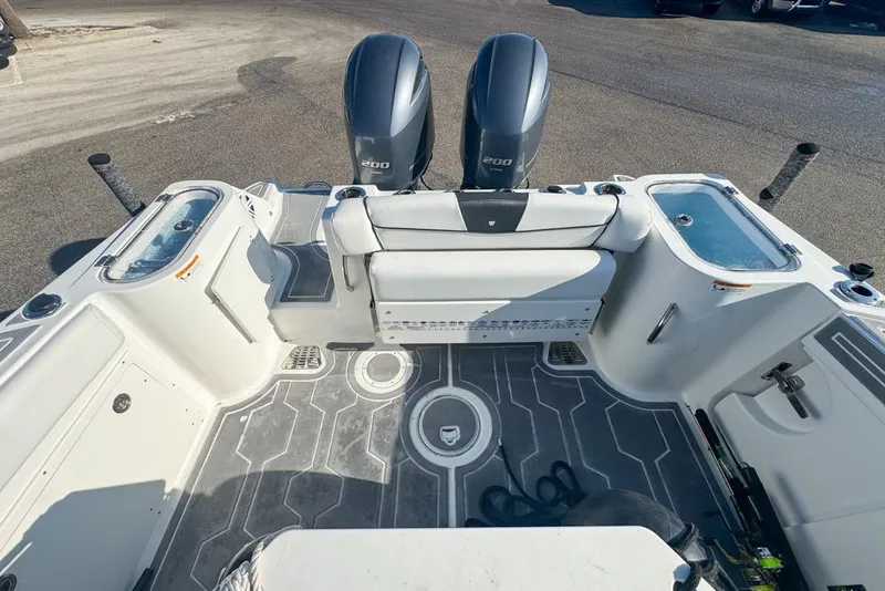 Slide: The Image of 2021 Wellcraft 262 Fisherman boat interior with dual engines and seating area. - 26