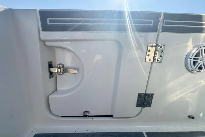 Slide: The Image of 2021 Wellcraft 262 Fisherman boat interior with storage compartment and speaker. - 36