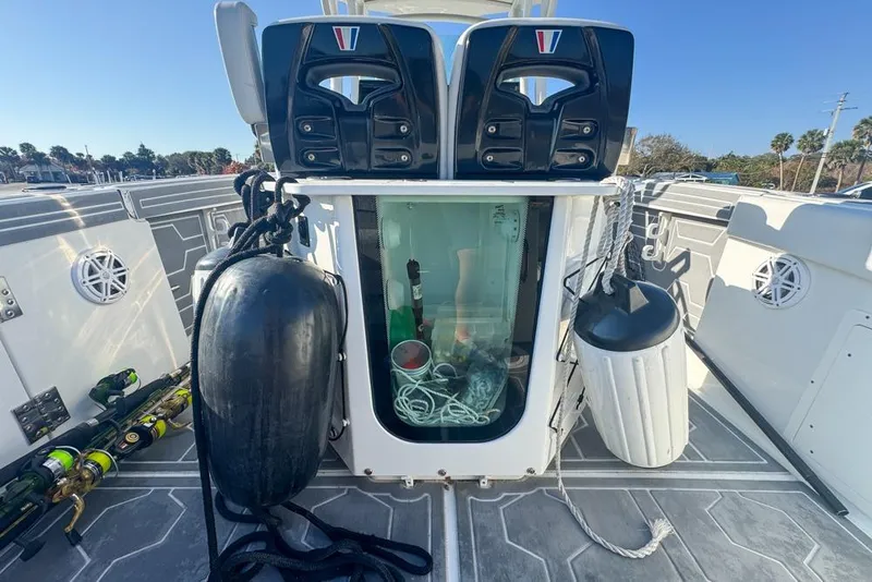 Slide: The Image of 2021 Wellcraft 262 Fisherman boat deck with storage, fishing gear, and fenders. - 40