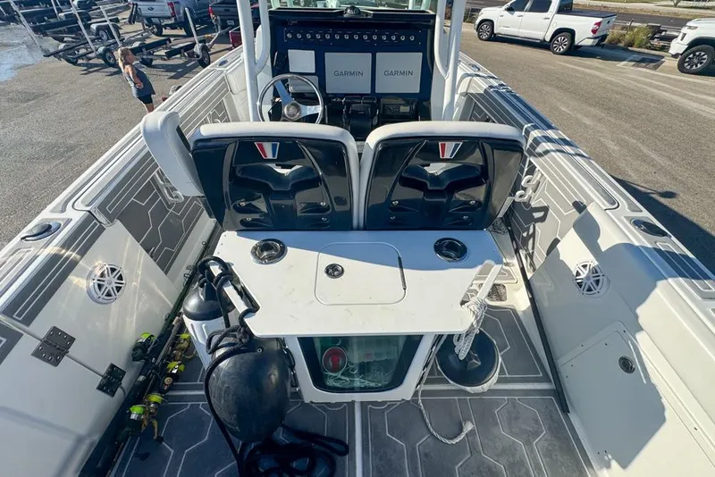 Slide: The Image of 2021 Wellcraft 262 Fisherman boat interior with fishing gear and Garmin displays. - 42