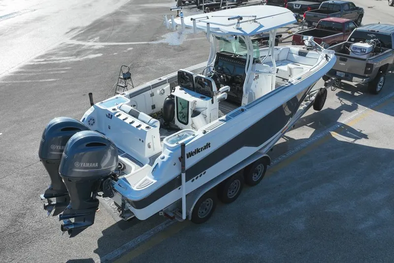 Slide: The Image of 2021 Wellcraft 262 Fisherman boat with dual Yamaha engines on a trailer. - 5