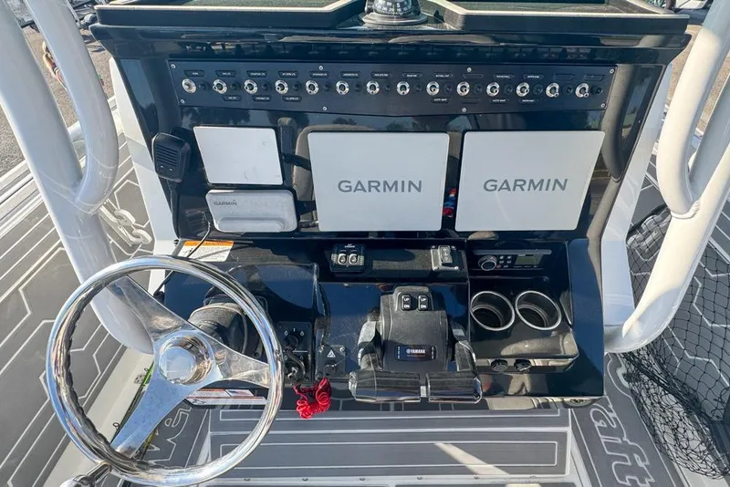 Slide: The Image of 2021 Wellcraft 262 Fisherman dashboard with Garmin displays and Yamaha controls. - 53