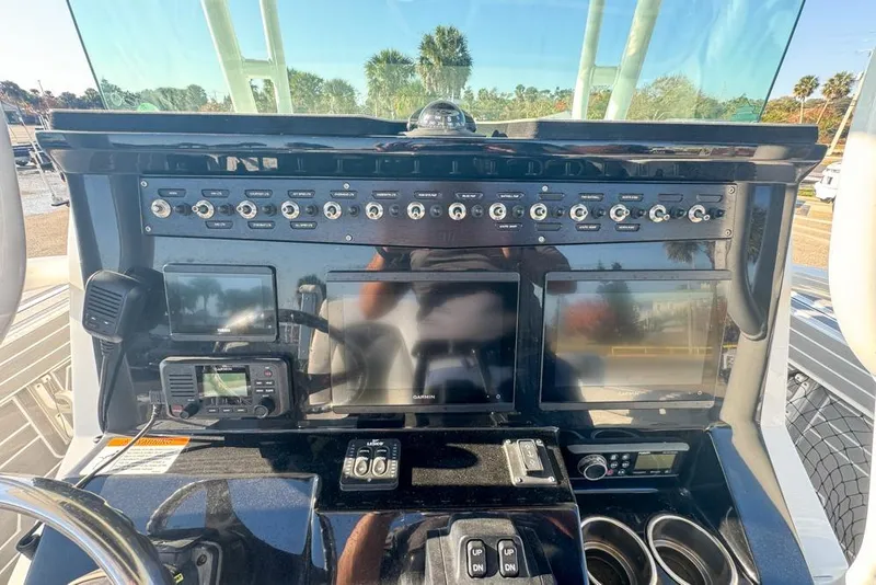 Slide: The Image of Control panel of a 2021 Wellcraft 262 Fisherman boat with navigation equipment. - 56