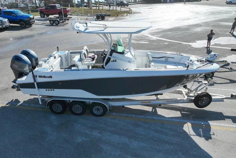 Slide: The Image of 2021 Wellcraft 262 Fisherman boat on trailer in parking lot. - 6