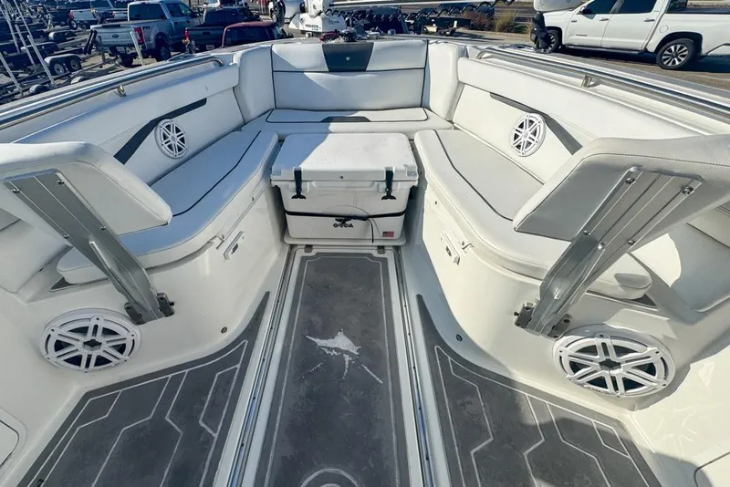 Slide: The Image of 2021 Wellcraft 262 Fisherman boat interior with cushioned seating and speakers. - 60