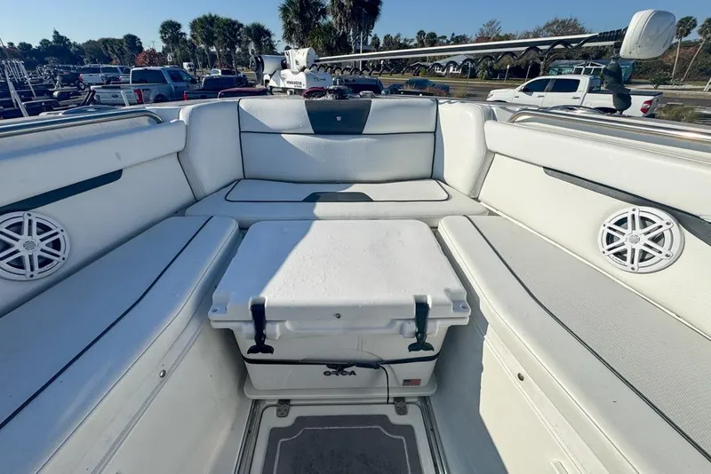 Slide: The Image of 2021 Wellcraft 262 Fisherman boat interior with seating and cooler. - 64