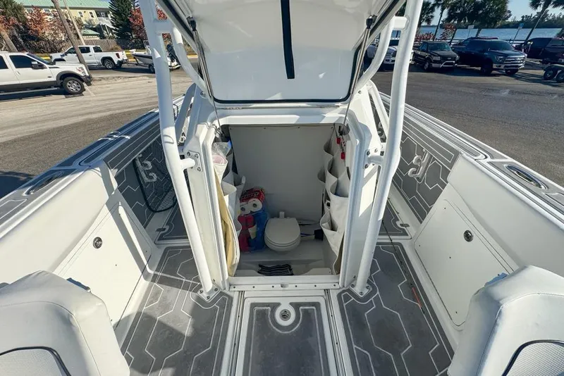 Slide: The Image of 2021 Wellcraft 262 Fisherman boat interior with open hatch and visible storage compartments. - 75