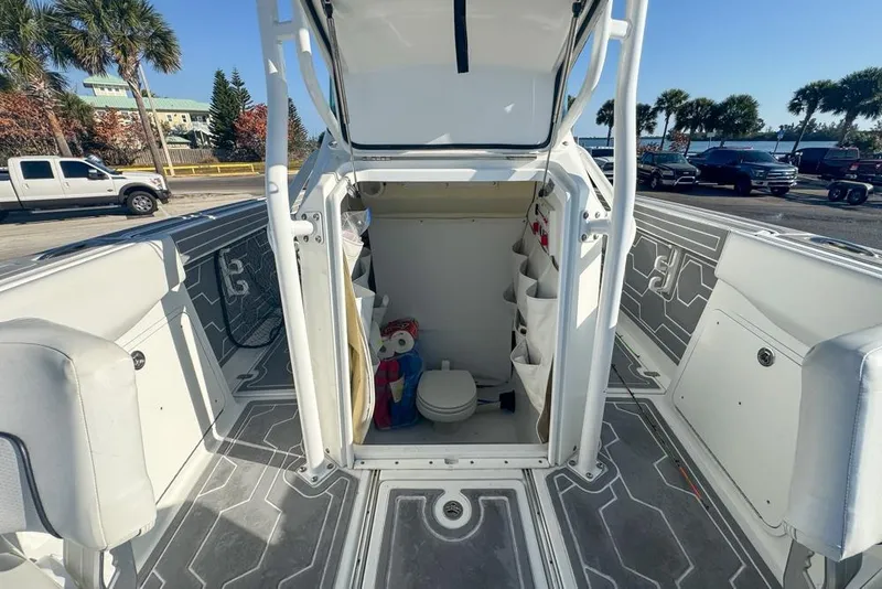 Slide: The Image of 2021 Wellcraft 262 Fisherman boat interior with open storage and toilet area. - 76