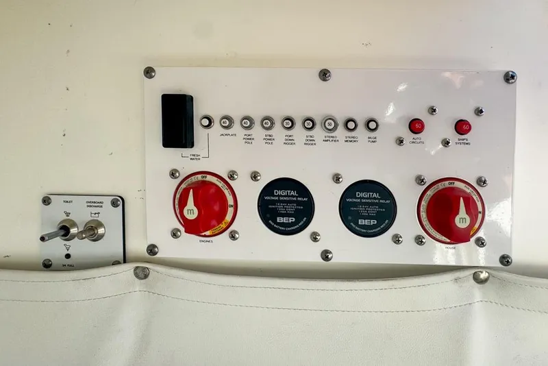 Slide: The Image of Control panel of a 2021 Wellcraft 262 Fisherman boat with switches and dials. - 78