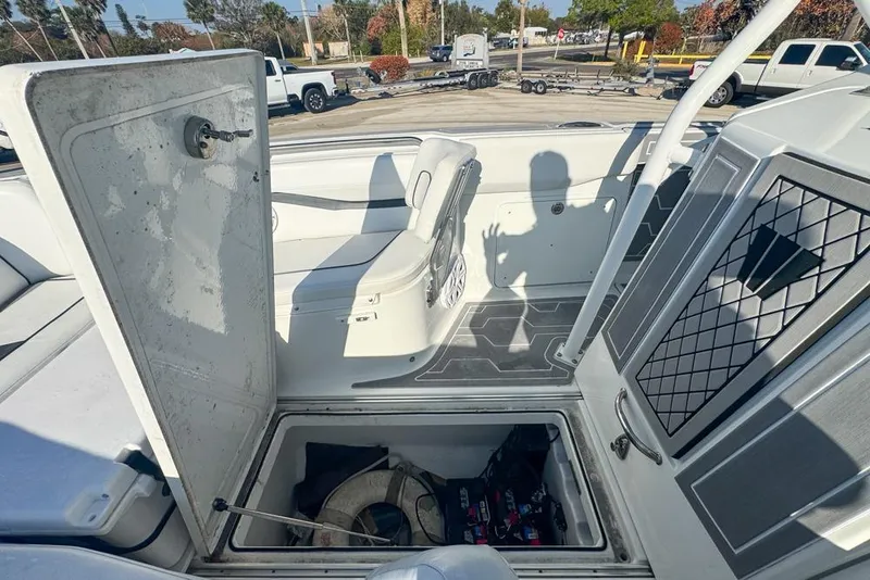 Slide: The Image of 2021 Wellcraft 262 Fisherman boat interior with open storage compartment and seating. - 82