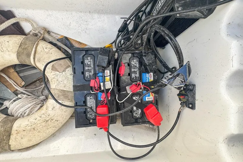 Slide: The Image of Battery setup on 2021 Wellcraft 262 Fisherman boat with life preserver and cables. - 83