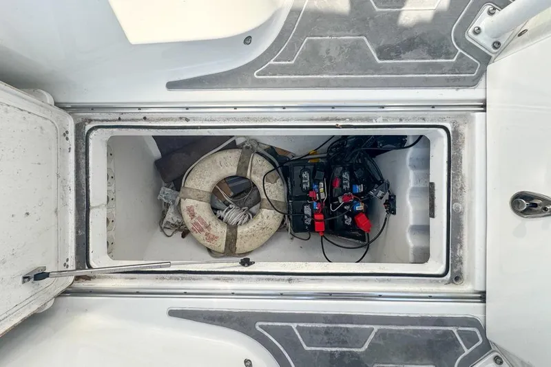 Slide: The Image of Open storage compartment on 2021 Wellcraft 262 Fisherman boat with life ring and equipment. - 84
