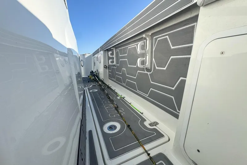 Slide: The Image of 2021 Wellcraft 262 Fisherman boat interior with fishing rods and sleek design. - 85