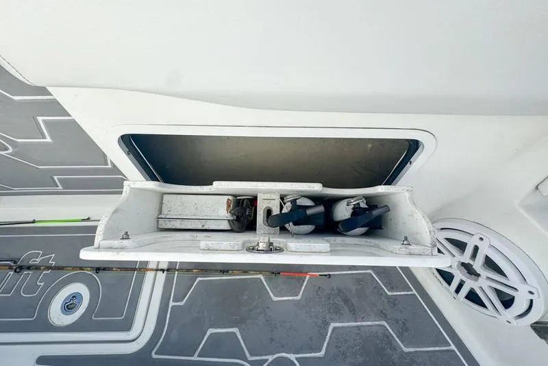 Slide: The Image of 2021 Wellcraft 262 Fisherman boat storage compartment with fishing gear and equipment. - 88