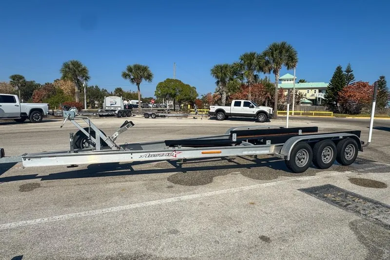 Slide: The Image of 2021 Wellcraft 262 Fisherman trailer parked in sunny lot with palm trees. - 96