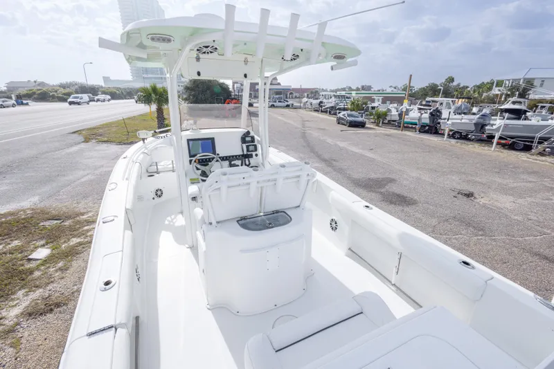 Slide: The Image of 2016 Sea Hunt Gamefish 25 boat with center console, parked near a road. - 12